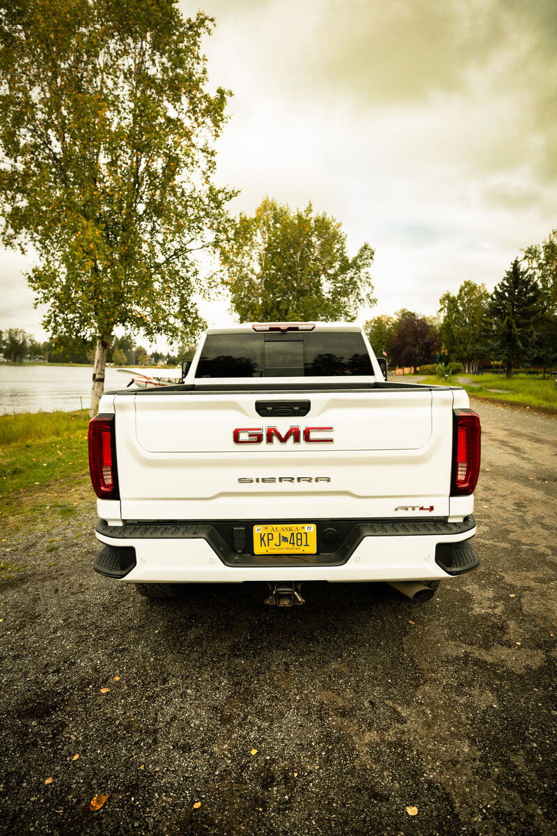 White GMC Sierra from the rear with the lake beyond