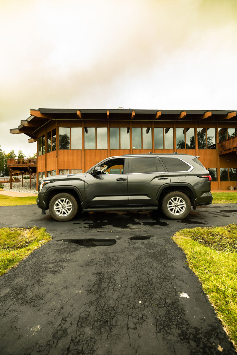 Toyota Sequoia parked in front of a timber lodge