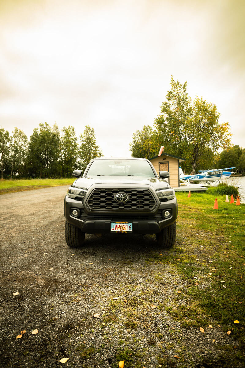 Toyota Tacoma parked near the float plane