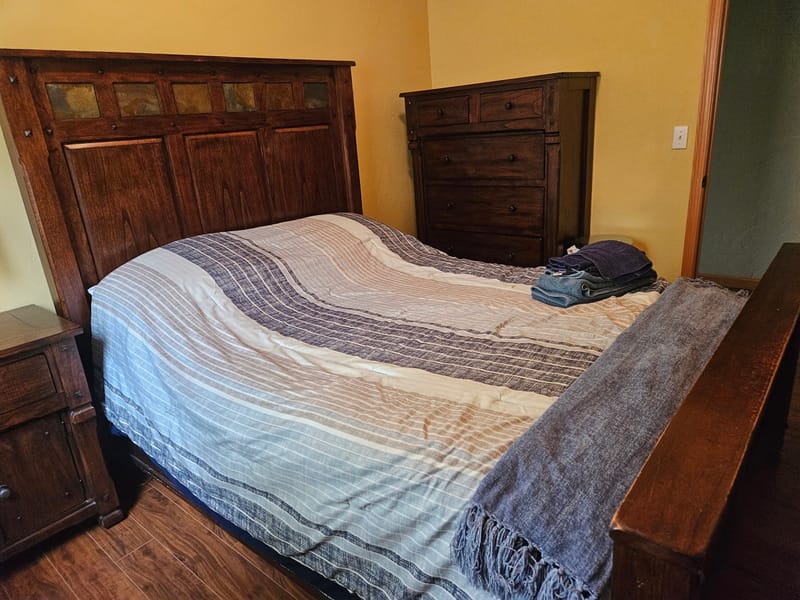 Bedroom with a carved wood bed and dresser