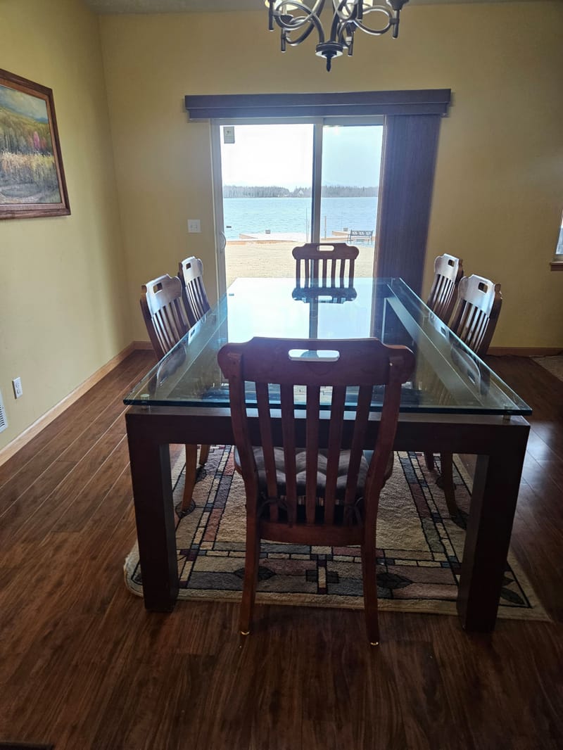 Glass-top table at a window onto the lake