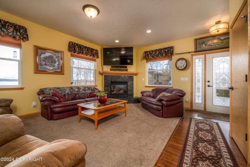 Living room with leather sofas facing a gas fireplace