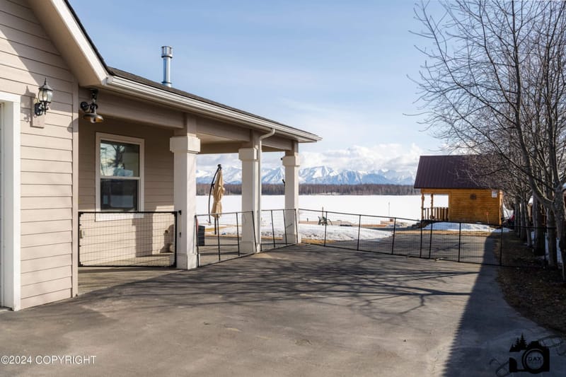 Covered porch and driveway with mountains beyond
