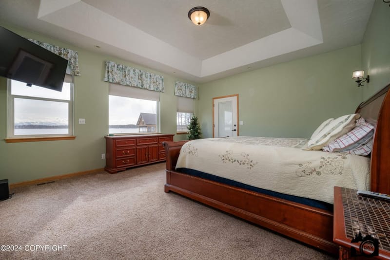 Primary bedroom with windows onto the lake