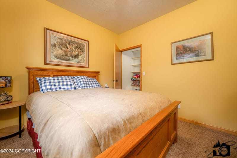 Bedroom with a queen bed and a sheepskin throw