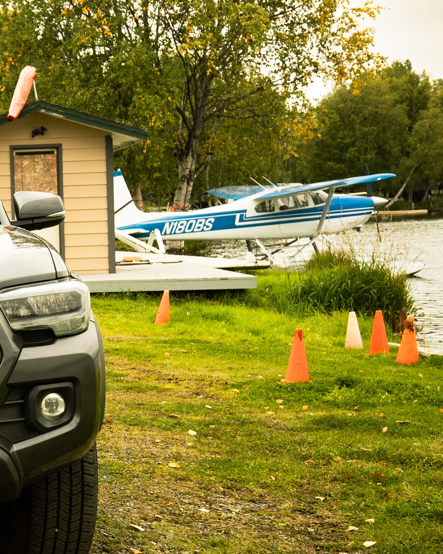 A blue and white float plane tied up at the shore of Lake Lucille